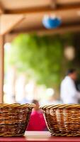 two wicker baskets on a red table photo