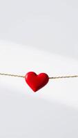 red heart hanging from a gold cord photo