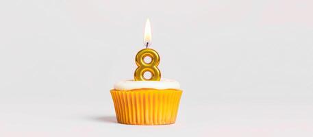 single lit candle cupcake with number eight photo