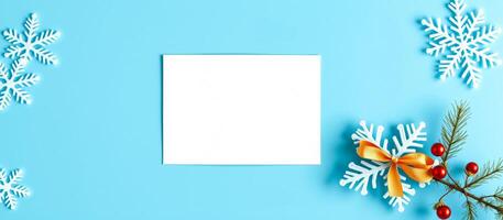 blank white card with white snowflakes on blue background photo
