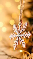 silver snowflake ornament hanging against a background warm golden lights photo