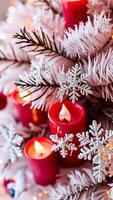 red candles sparkling snowflakes adorn a snowy tree photo