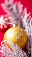 golden ornament on a white branch against a red background photo