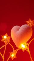 plush pink heart glows on a string snowflake lights photo