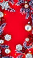 silver ornaments frosted pine branches create a festive border on a red background photo