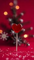 red heart-shaped lollipop stands out against a festive background photo