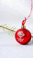 red christmas ornament with a silver snowflake design photo