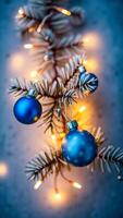 blue glass ornaments lights on a coniferous branch photo