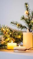 lit candles with pine branch string lights photo