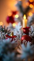 decorated arrangement with red gold ornaments a lit candle photo