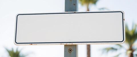 blank rectangular sign mounted on a rusted pole photo