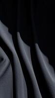 draped black fabric with textured surface photo