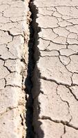 cracked earth with a deep fissure photo