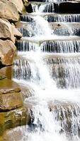cascading waterfall over smooth brown rocks photo