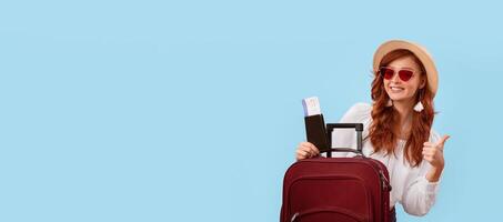 Summer Travel. Happy Traveler Girl Posing With Tickets, Passport And Suitcase Gesturing Thumbs-Up On Pink Studio Background. Copy Space, Panorama photo
