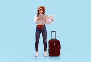 Travel Problem. Shocked Tourist Girl Holding Map Choosing Destination Standing With Suitcase On Pink Studio Background. Vertical photo