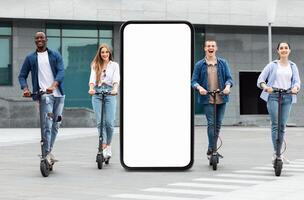 A group of four young adults races on electric scooters through a city environment, exuding joy and camaraderie. They are dressed casually, stand by huge phone with blank screen photo