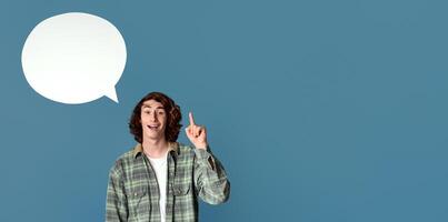 Funky young guy with speech bubble having creative idea on turquoise background, empty space for design photo