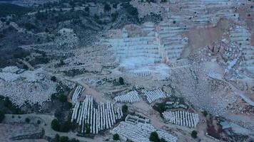 Aerial view of Open-air mining activity in a white marble mine. video