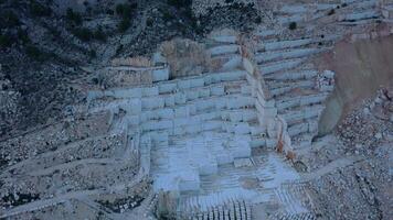 Aerial view of Open-air mining activity in a white marble mine. video
