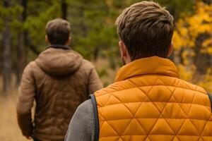 Two hikers exploring a vibrant Pine Grove forest during autumn with earthy and warm tones photo