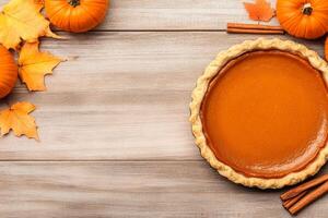 Freshly baked pumpkin pie with autumn leaves and pumpkins on a rustic wooden table photo