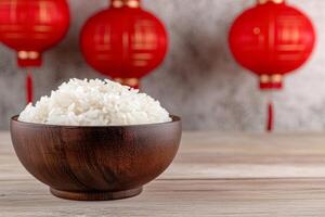 A wooden bowl filled with white rice surrounded by red lanterns in a modern oriental decor setting photo