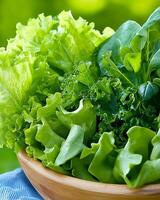 Fresh salad bowl filled with vibrant green ingredients complemented by a blue napkin for a healthy meal setting photo