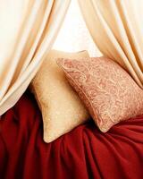 Cozy reading nook adorned with elegant pillows and warm blankets for a relaxing atmosphere photo