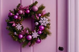 Elegant pink wreath adorned with ornaments and snowflakes on a festive door photo