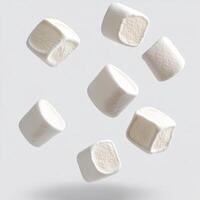 Floating marshmallows in mid-air creating a whimsical winter atmosphere for holiday graphics photo