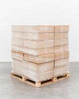 Neatly stacked cardboard boxes wrapped in plastic on a pallet in a well-lit logistics warehouse photo
