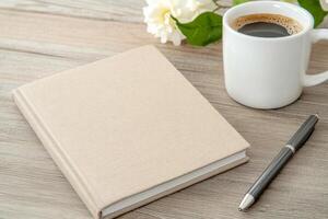 Stylish workspace featuring eco-stationery and coffee mug on a wooden desk in a serene, minimal environment photo