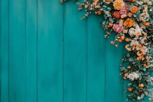 Boho garden setting with vibrant flower garland arch and wooden backdrop surrounded by lush greenery photo