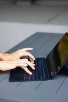 Close up of a womans hands on keyboard of lap top in the dark room, people working at home photo