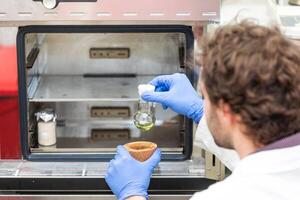 Young scientist in a research laboratory creating a scientific experiment, laboratory concept photo