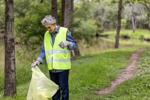Senior volunteer worker group enjoy charitable social work outdoor in cleaning up garbage and waste separation project at the park or natural forest for community service and recycle concept photo