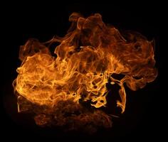 Flame of burning fire of explosive fireball isolated on dark background for abstract graphic design photo