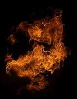 Fire and burning flame of explosive fireball isolated on dark background for abstract graphic design photo