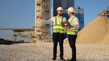 Team Engineers in hardhat use laptop to plan the work of a stone quarry video