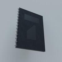 A black notebook with a white cover on a gray background photo
