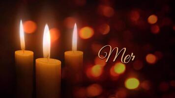 Candles Merry Christmas Lights 4K features three holiday candles flickering in an atmosphere of floating diffused lights with an animated hand-written Merry Christmas video