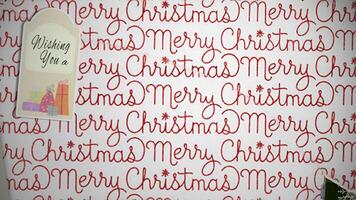 Merry Christmas Happy New Year Package Open 4K Loop features a present with Christmas wrapping paper tearing open layer by layer to reveal a Merry Christmas and Happy New Year message. video