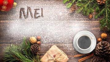 Merry Christmas Desk Animated Message 4K features a wooden surface with Christmas objects and snow and a hand-written Merry Christmas message appearing in the snow. video