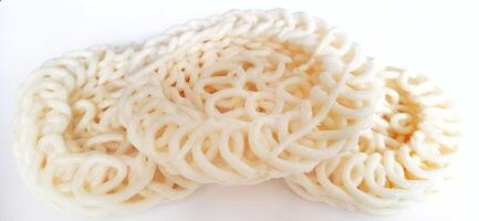 White noodle crackers or kerupuk putih or kerupuk warung made from tapioca flour, snack food from Indonesia isolated on white background photo