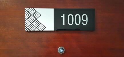 Modern room number hotel with 1009 on the wall door photo