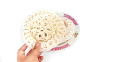 White noodle crackers or kerupuk putih or kerupuk warung made from tapioca flour, snack food from Indonesia isolated on white background photo