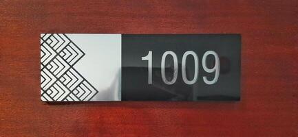 Modern room number hotel with 1009 on the wall door photo