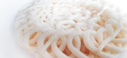 White noodle crackers or kerupuk putih or kerupuk warung made from tapioca flour, snack food from Indonesia isolated on white background photo