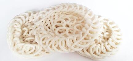 White noodle crackers or kerupuk putih or kerupuk warung made from tapioca flour, snack food from Indonesia isolated on white background photo